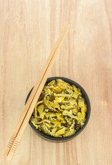 Fried pickle with egg on wooden background