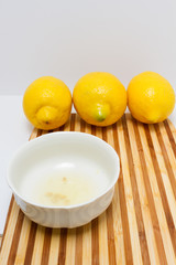 Freshly squeezed lemon juice inside a white bowl