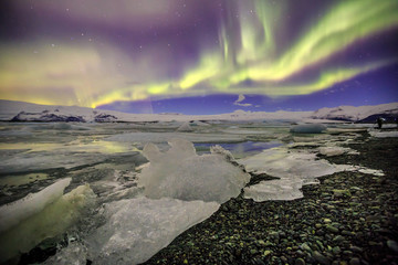 Auroral over the glacier lagoon Jokulsarlon in Iceland.