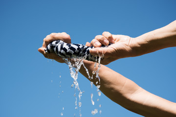 Squeezing of wet fabric.