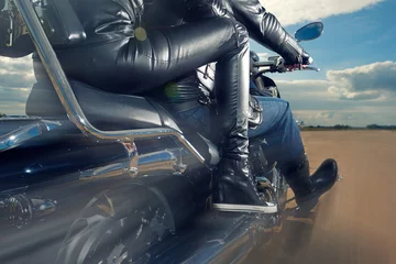 Papier Peint photo autocollant Moto Biker Man and woman wearing black leather jackets riding on motorcycle
