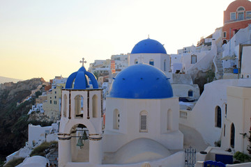 Sunset view with orthodox church,Oia, Santorini island, Greece