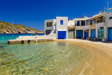 Scenic Firopotamos village (traditional Greek village by the sea, the Cycladic-style) with sirmate - traditional fishermen's houses, Milos island, Cyclades, Greece.