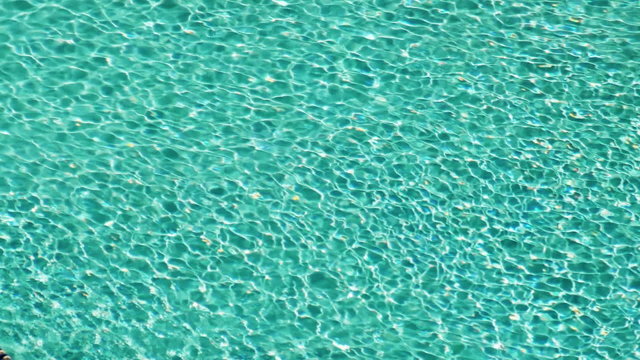 Dappled Pool Water Ripple Background. Swimming pool water abstract background with seamless loop.