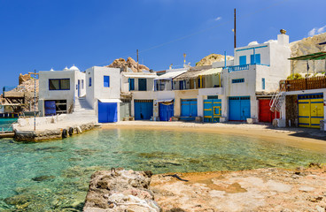 Scenic Firopotamos village (traditional Greek village by the sea, the Cycladic-style) with sirmate - traditional fishermen's houses, Milos island, Cyclades, Greece.