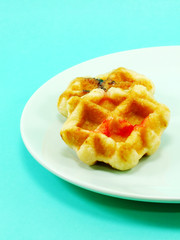 homemade sweet waffles with chocolate and strawberry sauce