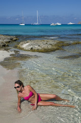 Girl lying on the shore and in the clear