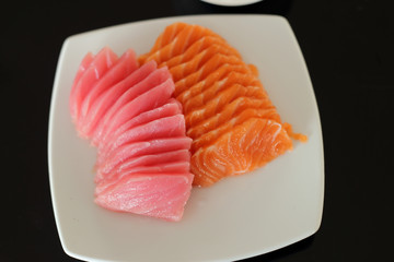 salmon and maguro sashimi on white dish.
