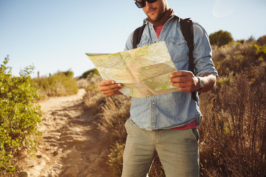 Man in countryside with a map