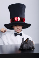 little magician with rabbit studio shot