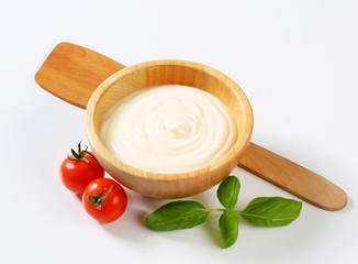 Creamy sauce in wooden bowl
