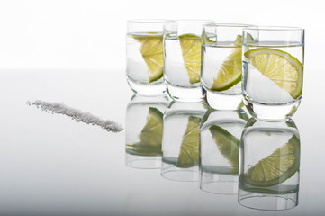 Four shots of vodka with lemon