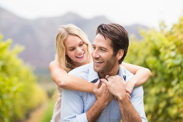 Young happy woman embracing young handsome man