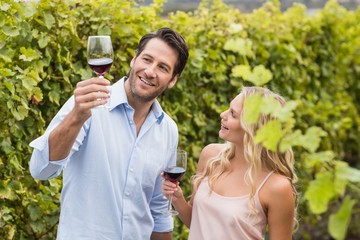 Obraz premium Young happy couple talking about wine