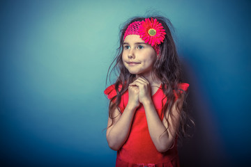 a girl of seven European appearance brunette in a bright dress f