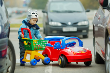 little boy on supermarket parking