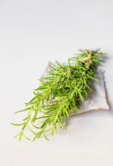 rosemary on the paper and white wooden table