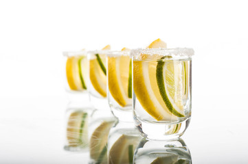 Four shots of vodka with lemon