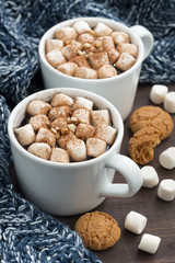 Two cups of cocoa with marshmallows, vertical