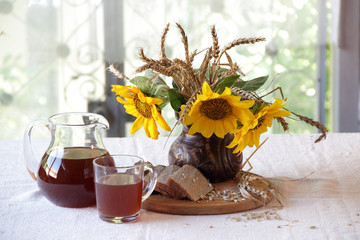House kvass (kvas) and a bouquet from sunflowers