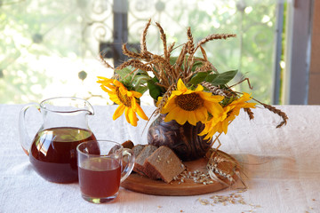 Still-life with a bouquet of sunflowers and kvass (kvas) п вр