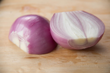 Peeled red onion, shallots on wood cutting