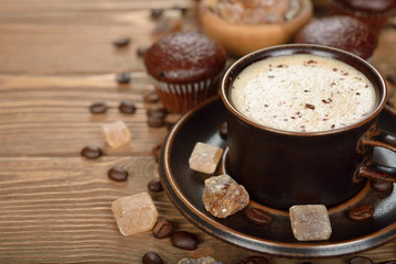 Cup of coffee and chocolate muffins