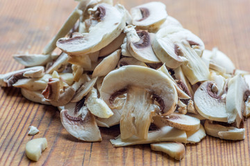 Fresh champignon mushrooms on a wooden deck