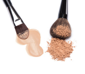 Liquid foundation and loose cosmetic powder with makeup brushes