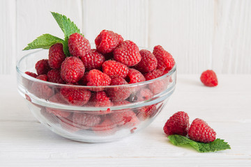 A glass of strawberry smoothie on white wooden table