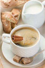 Morning coffee with cinnamon, milk, sugar and nut cookies