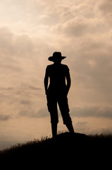 Silhouette of the woman on the top of the mountain  