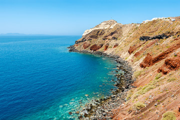 Fototapeta na wymiar Colorful rocky shore on Santorini island, Greece