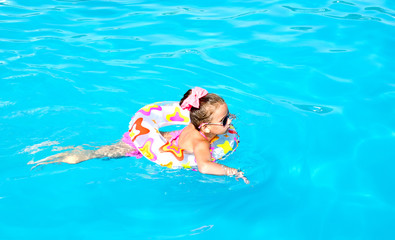 Smiling little girl in swimming pool