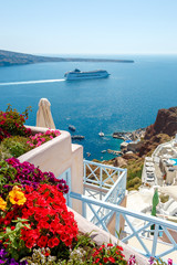 Flowers, buildings and cruise ship in Oia, Santorini