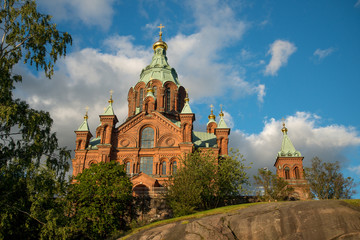Fototapeta na wymiar Uspenski Cathedral, Helsinki On Hill At Summer Sunny Day. Red Church - Tourist destination In Finnish Capital, Finland.