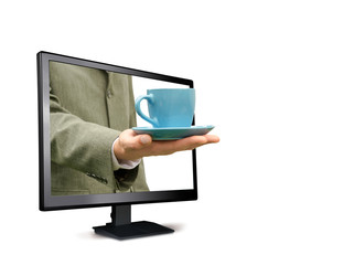 man holds a cup from the monitor