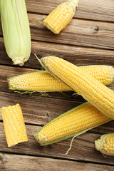 Corns on a brown wooden background
