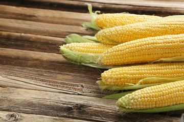 Corns on a brown wooden background
