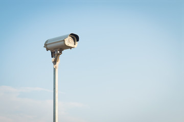 Security camera on blue sky background