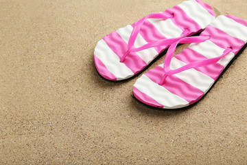 Pair of flip flops on sand beach