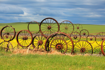 Rusty wheels fence with scenic background