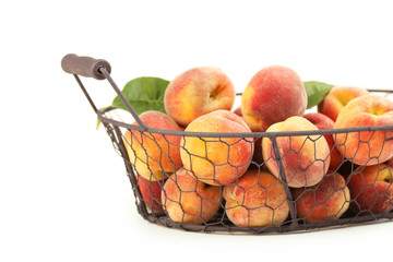 Fresh peach fruit in basket on a white background