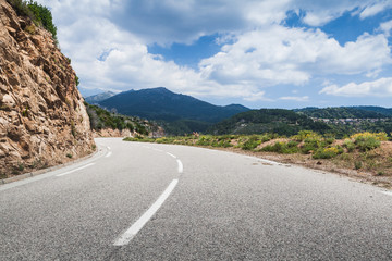 Mountain road with dividing line on asphalt