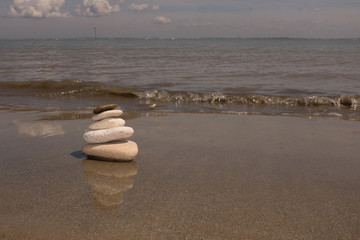Fototapeta na wymiar stack of stones on sand