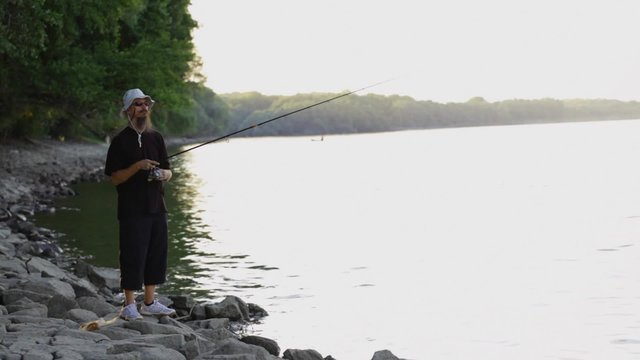 HD 1080 static: Sports fisherman fishing at Danube river