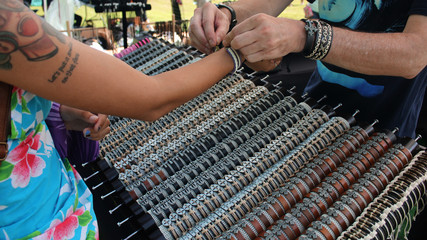 Participant buying souvenirs at stall at Polynesian festival