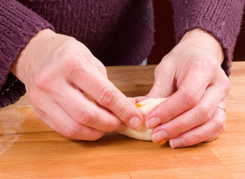 Woman's hands making a carrot cake