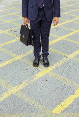 Businessman on asphalt