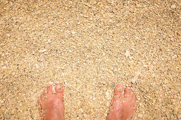 Man feet standing in sand
